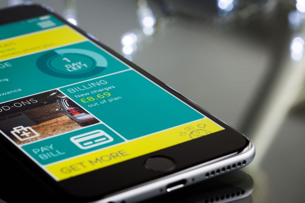 Crafting Captivating Headlines: Your awesome post title goes here Close-up of a smartphone displaying a billing app interface on a reflective surface.